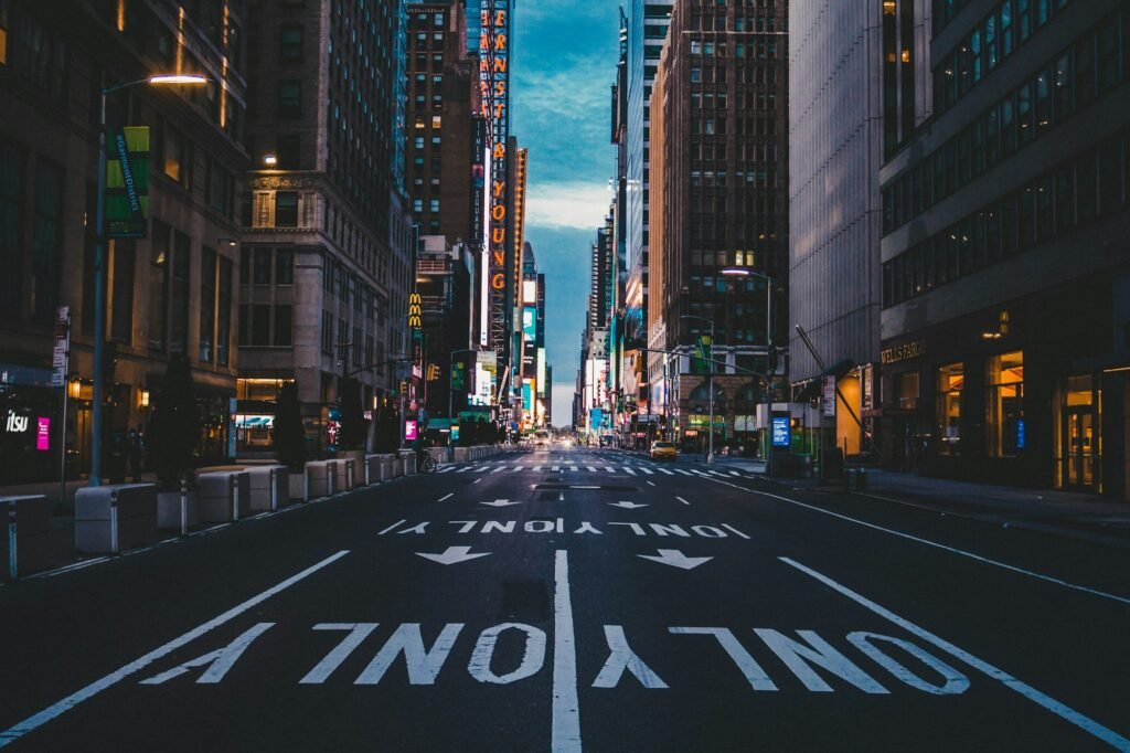 City street with lane markings between tall buildings