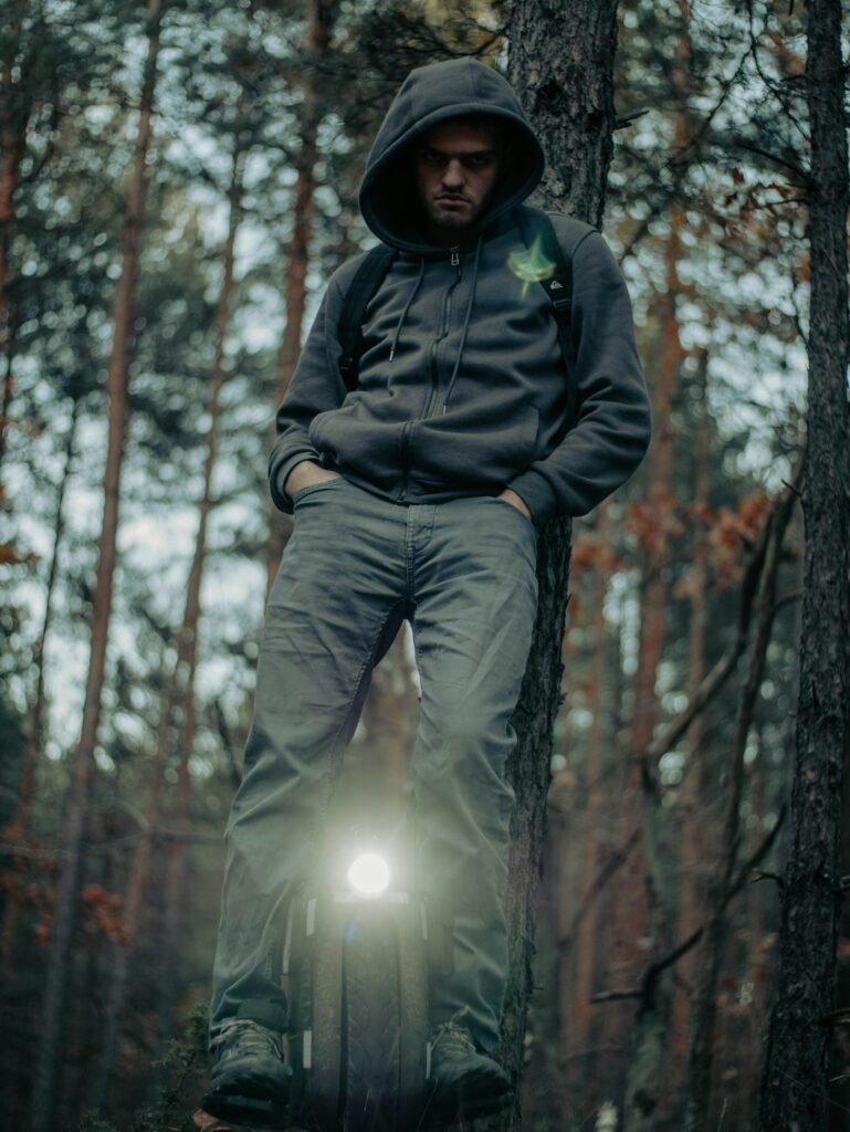 Rider balancing on an electric unicycle among trees