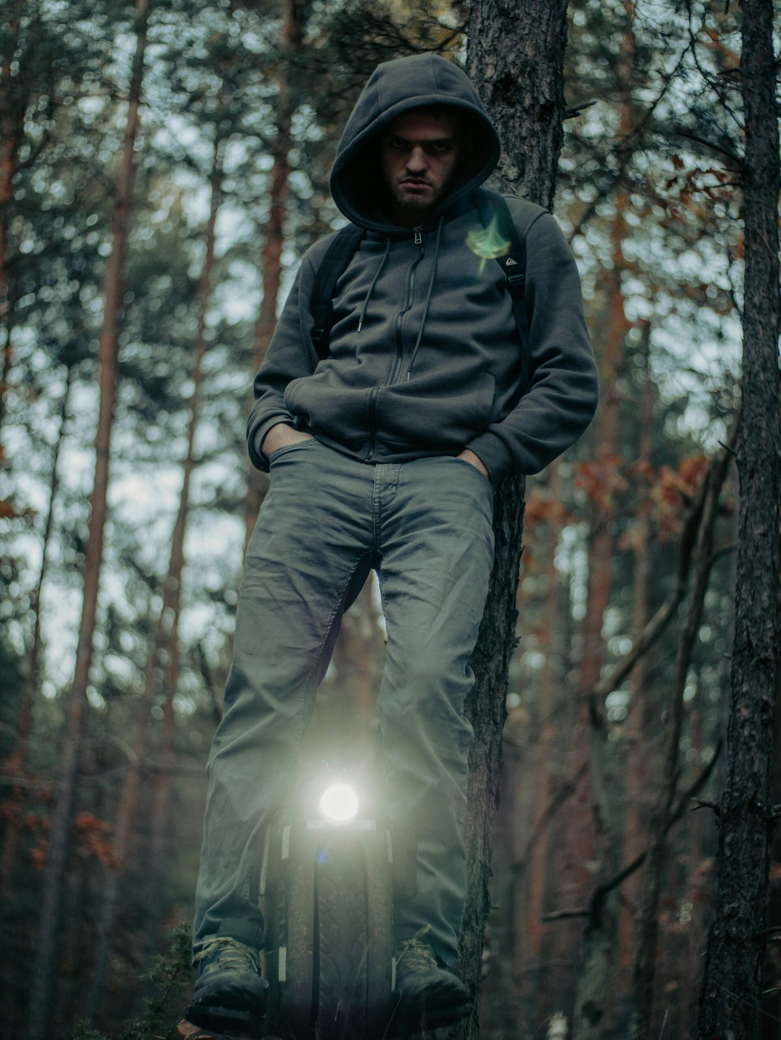 Rider balancing on an electric unicycle among trees