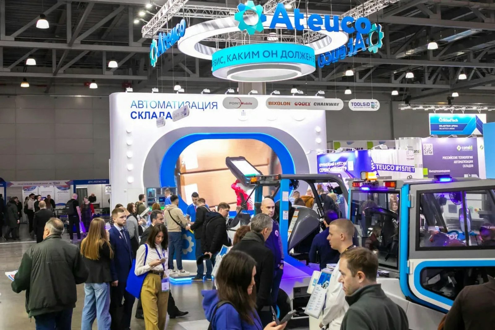 Visitors at a technology trade show booth
